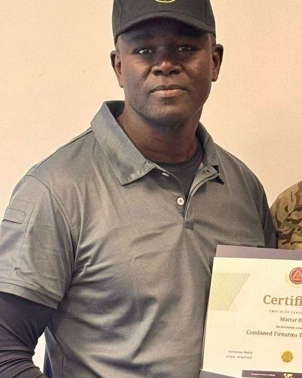Mactar Diop receiving a combined firearms training certificate